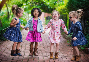 Four girls modeling Worthy Threads girls dresses