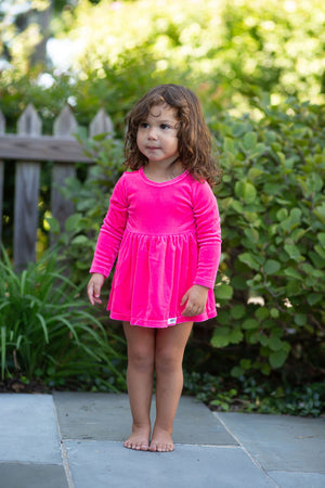 Toddler modeling baby bubble romper in hot pink stretch velvet