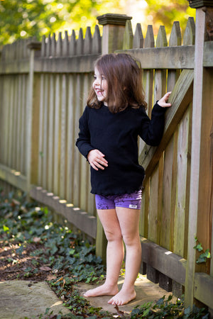 Toddler in purple robots biker shorts