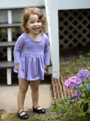Baby toddler long sleeve bubble romper in purple on model