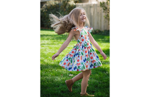 Girl modeling colorful veggie print dress